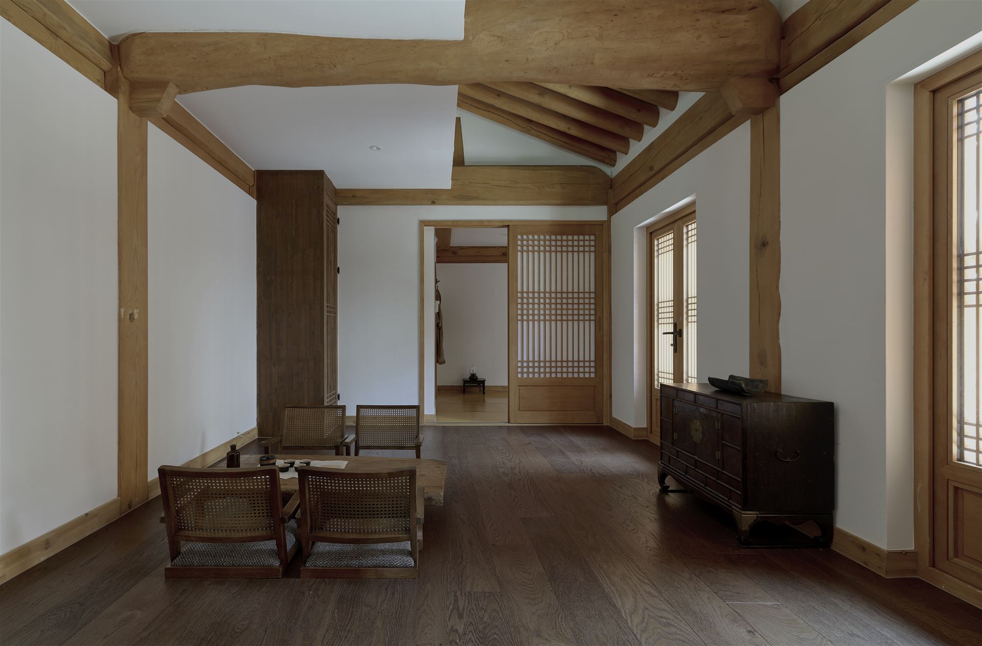 The living room with low chairs and a wooden table