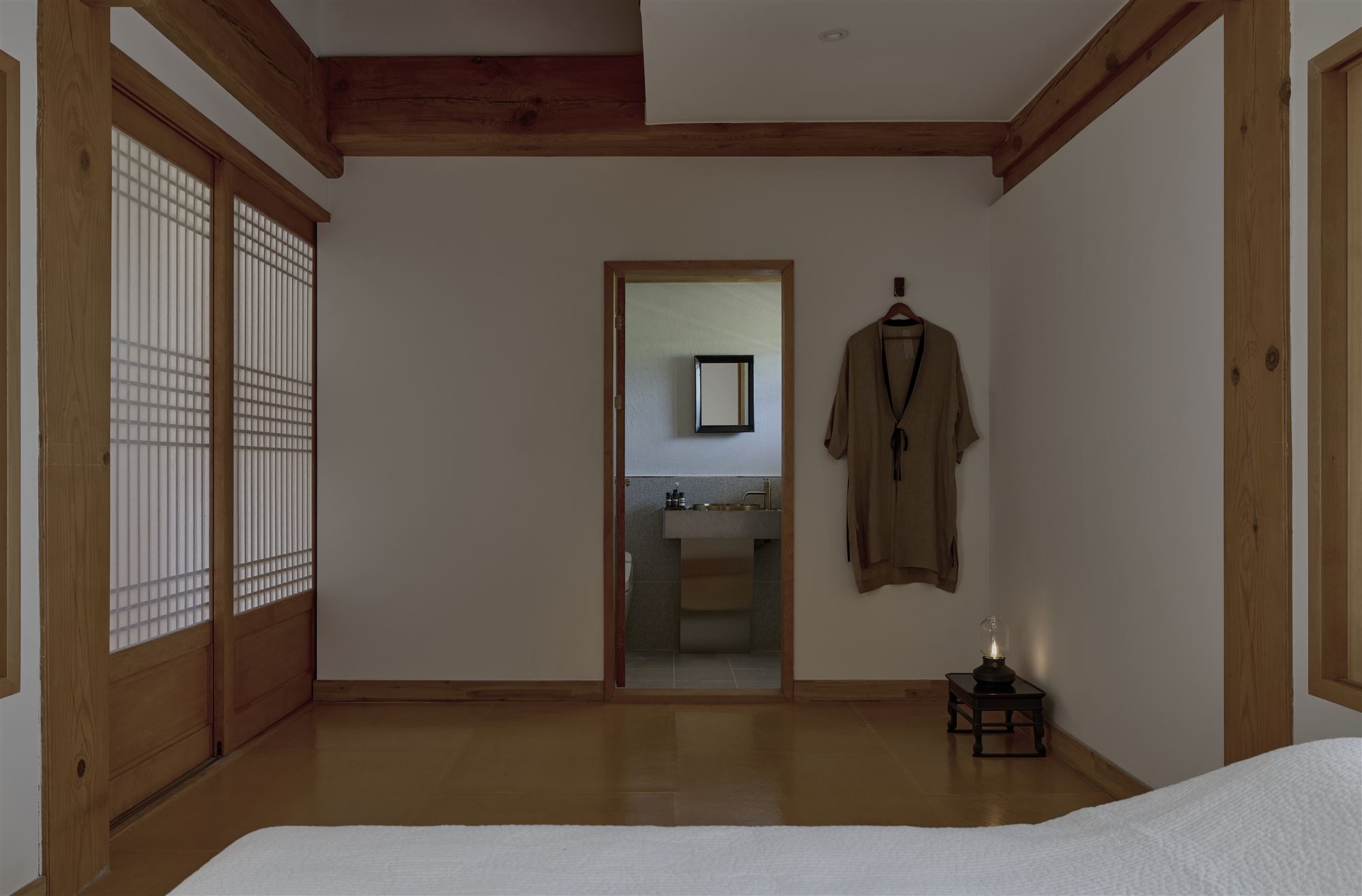 The path leading to the bathroom and the bedroom where robes are hung
