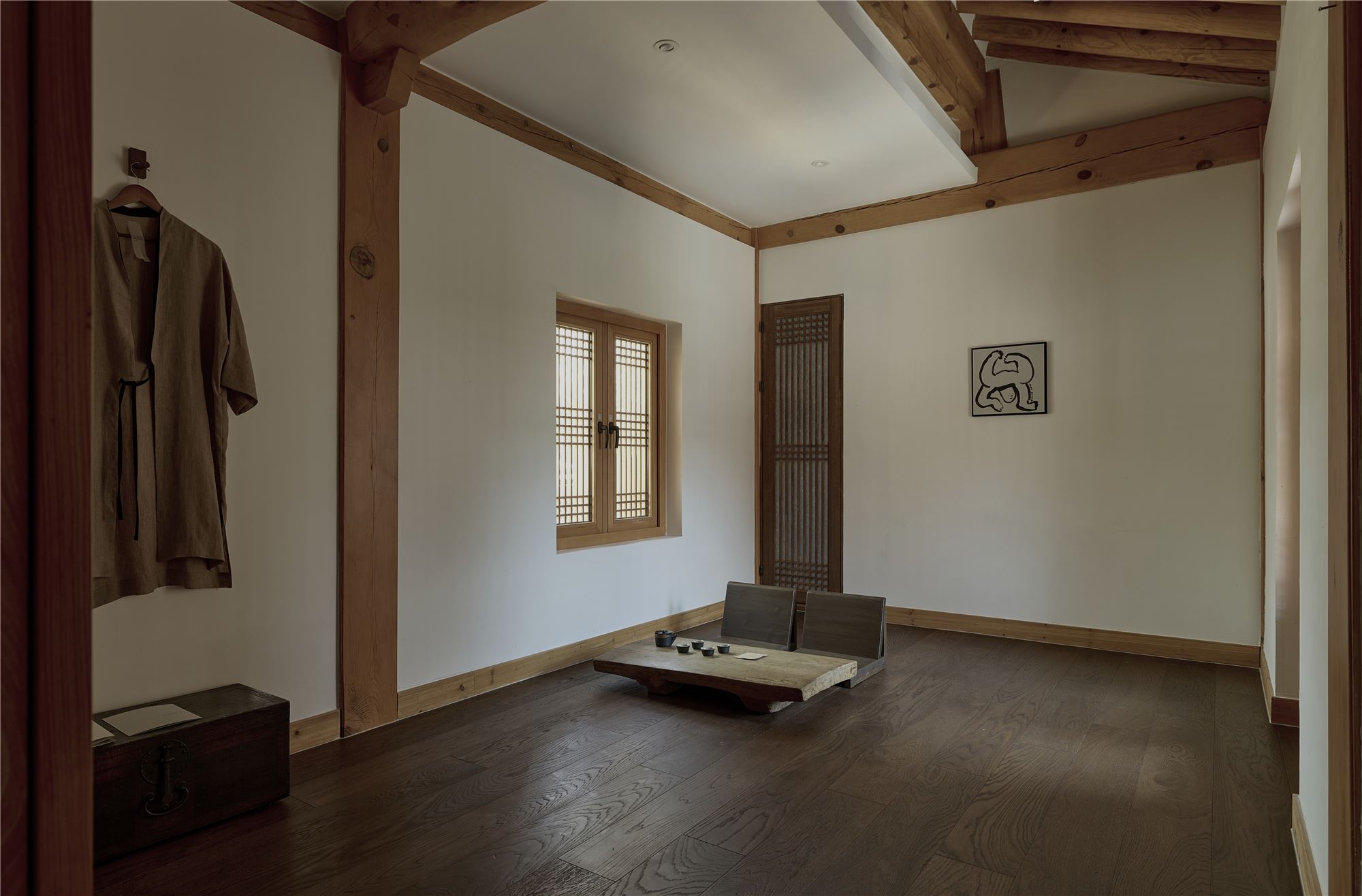 An ondol living room with robes and a low table