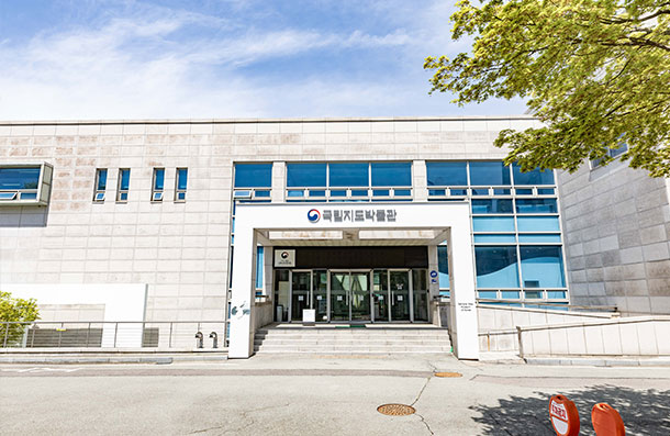 Front exterior of the National Map Museum showing the granite-finished entrance and sign